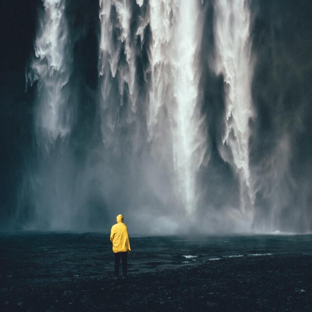 Waterfall Skogafoss with men